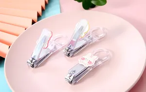 Macro view of transparent nail clippers featuring cute kawaii bear and rabbit stickers