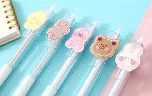 Macro view of transparent gel pens decorated with cute cartoon animal character patches