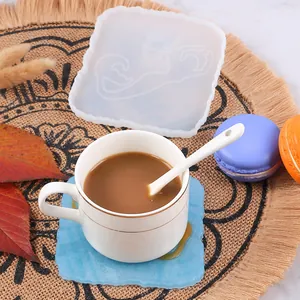 Square silicone mold for DIY resin coasters featuring a mermaid pattern in a lifestyle setting