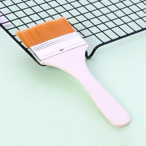 Detailed close-up view of a high-quality nylon pastry brush with a natural wooden handle