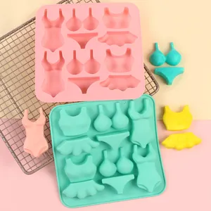 Close-up detail of bikini and swimwear shaped silicone molds for DIY fondant cake decoration