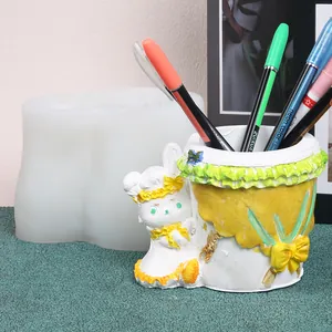 Detail of cute rabbit planter silicone mold with finished plaster pen holder