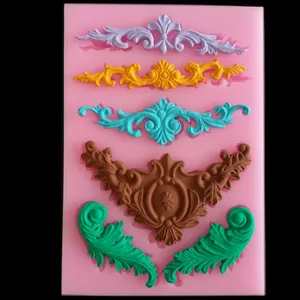 Macro view of a Baroque pink silicone mold with colorful fondant decorative pattern details.
