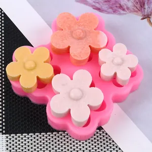 Detailed view of a pink floral silicone mold featuring colorful DIY soap flowers inside.