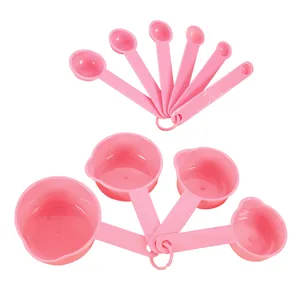 Top view of 10-piece pink plastic measuring spoon and cup set with embossed scales.