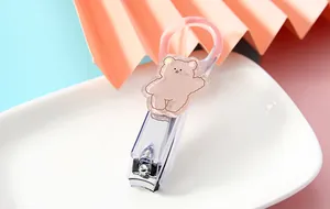 Detailed view of a cute cartoon bear decorative piece on a transparent nail clipper