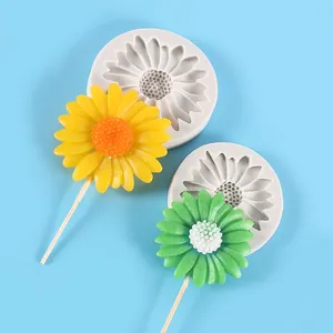 Detailed view of daisy silicone molds and finished sunflower shaped fondant lollipops