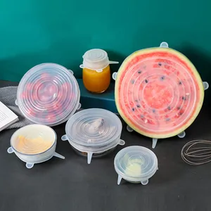 Set of reusable silicone stretch lids covering various food containers and fruit