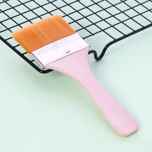 Close-up of a professional nylon bristle basting brush with a natural wooden handle