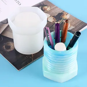 Detail showing a threaded silicone mold and its blue marbled resin pen holder