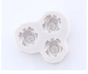 Detailed top-down view of three rose cavities in a flexible silicone mold for DIY baking