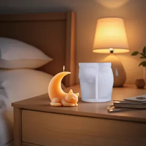 Detailed view of DIY cute cat moon silicone mold with finished orange scented candle