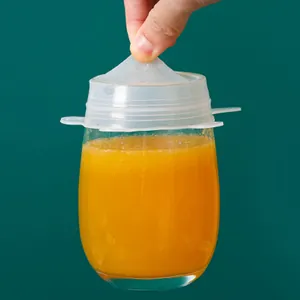 Flexible food-grade silicone stretch lid sealing a glass jar with juice