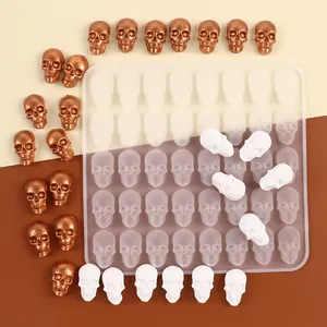Detail shot of Halloween skull silicone mold with finished bronze and white candy skulls