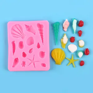 Detailed view of sea shell and starfish silicone mold with finished fondant pieces