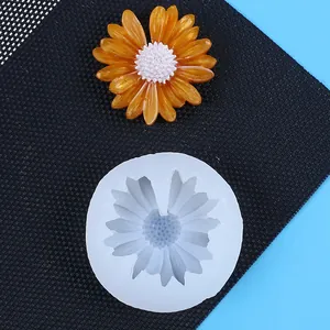 White daisy silicone mold with a finished orange resin flower for DIY cake decoration