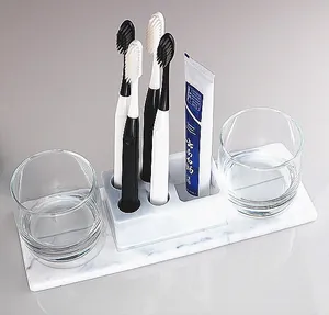 White marble toothbrush and cup holder tray organized with bathroom accessories setup