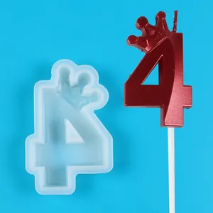 Detailed view of crown number 4 silicone mold alongside its red metallic finished candle