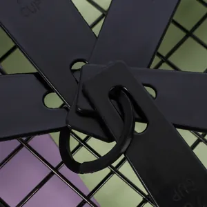 Detailed macro view of black plastic measuring spoons set held by a storage ring