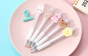 Detailed view of five white retractable gel pens with cute cartoon animal character patches