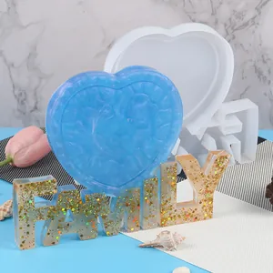 Vista dettagliata degli stampi in resina a cuore e Family con pezzi glitterati