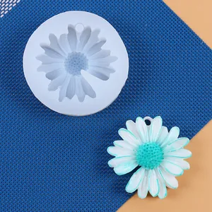 Detailed macro view of white daisy silicone mold and finished floral resin ornament
