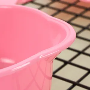 Macro view showing the smooth rim and material of a pink plastic baking measuring spoon
