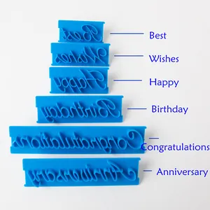 Detail view of 6 blue fondant stamps with cursive Best Wishes and Birthday phrases.