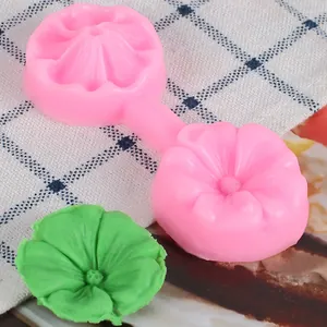 Macro view of a 3D pink silicone flower petal fondant mold with green leaf sample.