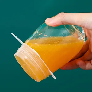 Detailed view of flexible silicone lid sealing a glass cup to prevent liquid leaks.