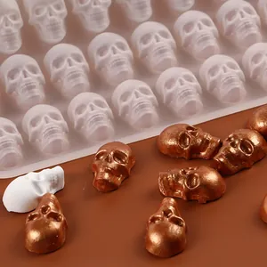 Close-up of Halloween skull silicone mold with metallic bronze candy samples