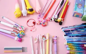 Detail view of various colorful cartoon pens, refills and keychains from a blind box set