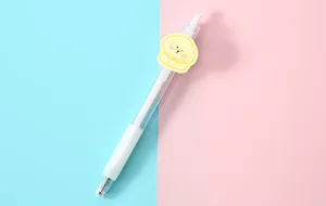 Close-up of a transparent gel pen featuring a cute yellow cartoon puppy decorative patch