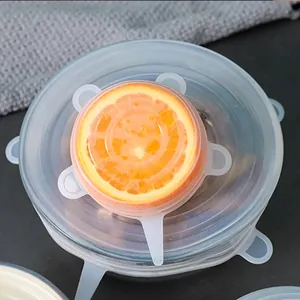 Food-grade silicone stretch lids for sealing glass bowls and sliced fresh oranges