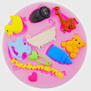 Detailed view of pink silicone mold with baby-themed shapes like bottle and bear