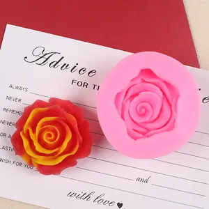 Macro detail of a 3D rose silicone mold alongside a finished red floral fondant piece