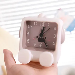 Minimalist cute pink cartoon mini desk alarm clock for kids held in hand for size
