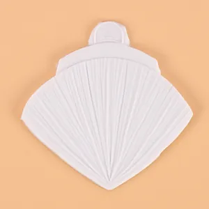 Close-up view of a fan-shaped white silicone mold for DIY cake decorating