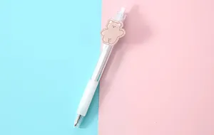 Detail view of a cartoon transparent gel pen with a cute bear patch accessory for students