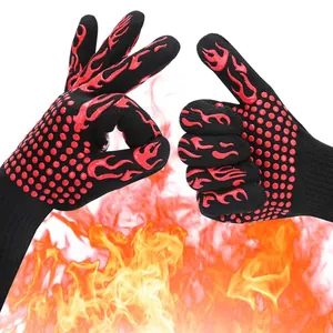 Detail of heat-resistant BBQ gloves with red silicone flame patterns over fire