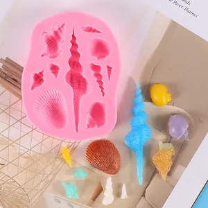 Detail view of pink silicone ocean theme mold with colorful conch and shell samples
