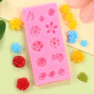Macro view of pink silicone flower mold featuring various rose and petal patterns for DIY