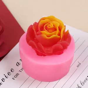 Close-up detail of a pink 3D rose silicone mold with a vibrant wax flower inside
