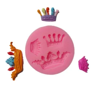 Pink silicone mold for mini crowns with finished fondant examples