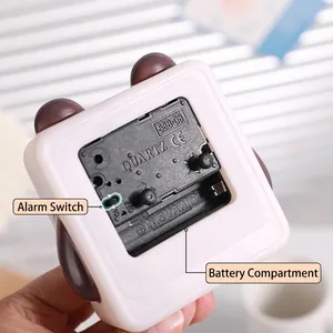 Back view of cute children's alarm clock showing battery compartment and controls