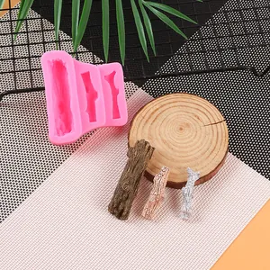 Detailansicht der rosa Silikonform Ast mit realistischer Holzstruktur und fertigen Stücken
