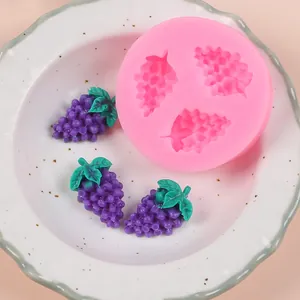 Detailed view of pink grape-shaped silicone fondant mold with finished fruit replicas