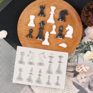 Detail view of a 3D chess piece silicone mold with finished black and white resin pieces