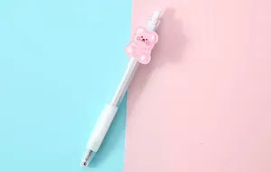 Detailed view of a transparent click gel pen with a cute pink cartoon bear patch decoration.