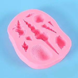 Detailed view of pink silicone mold featuring various ocean shell and conch shapes